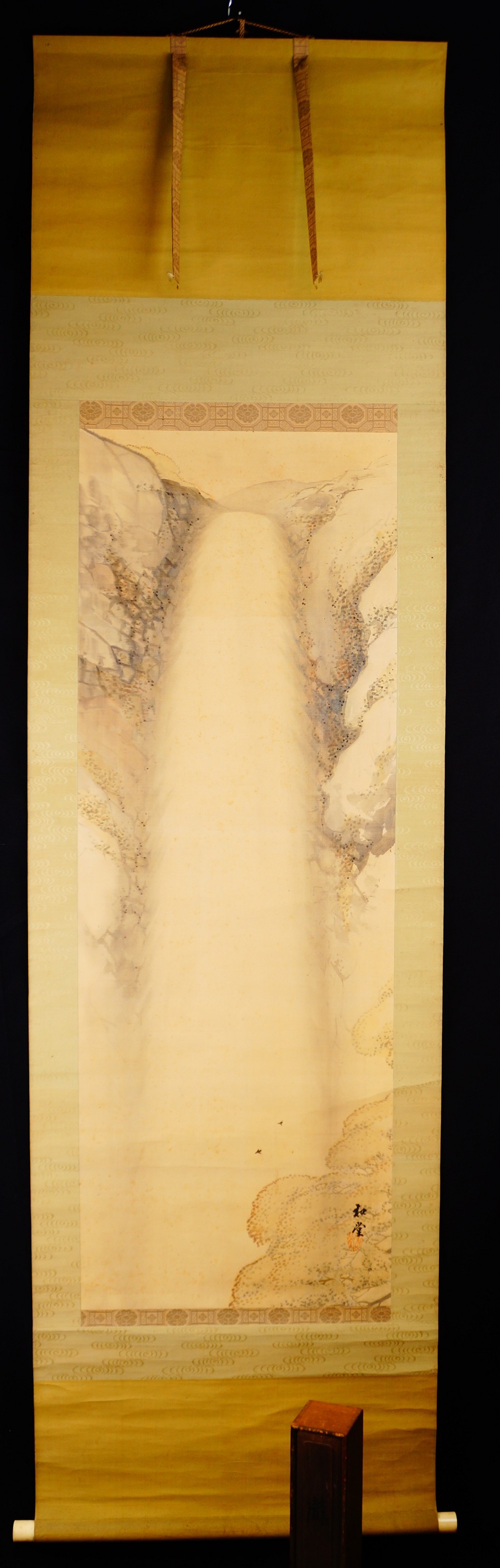 Waterfall in the mountains as hanging scroll by Nakagawa Wado in full view with green-gold border mounting