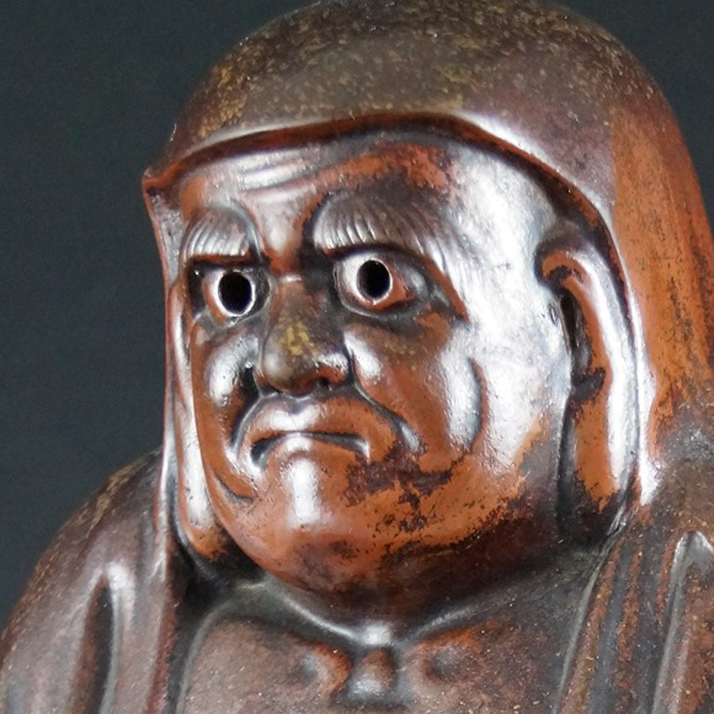 Bodhidharma Daruma wide-open eyes Bizen ware motif close-up preview